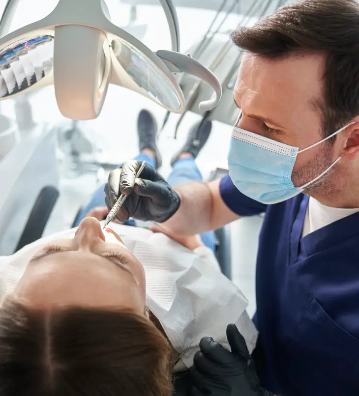 Dental professional cleaning a patient’s teeth
