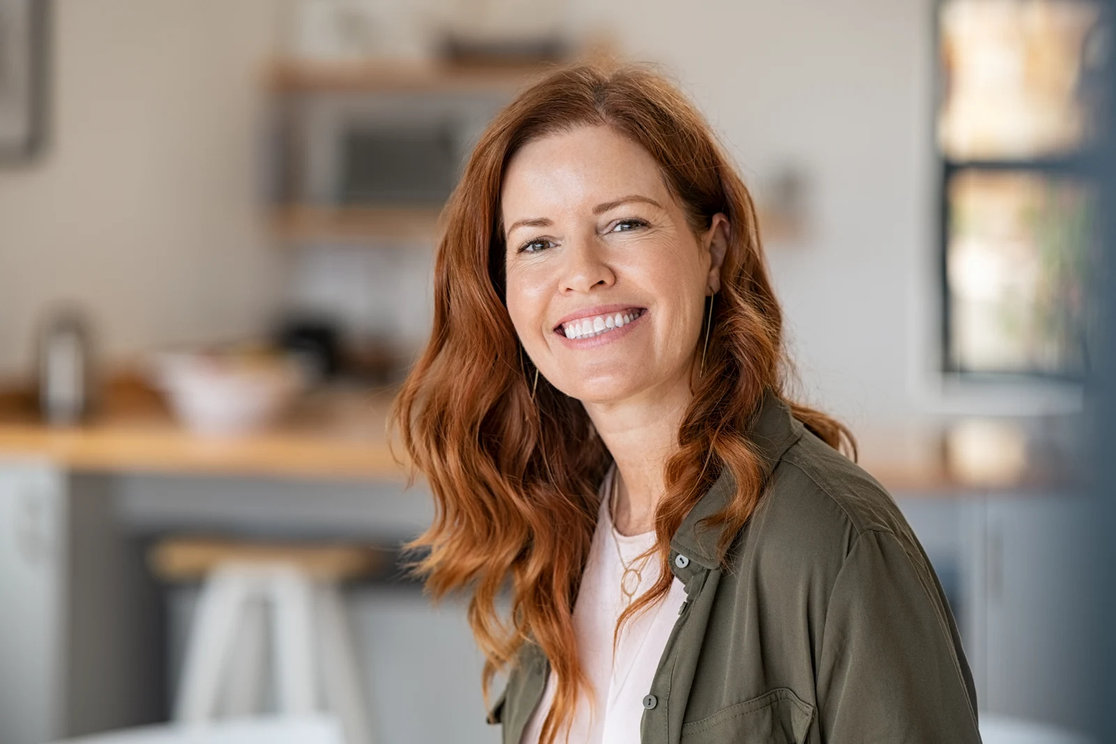 Smiling woman with long red hair