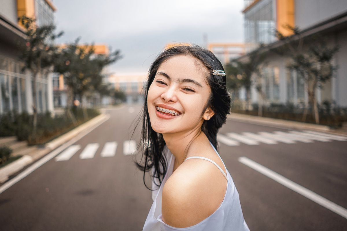 Smiling young woman wearing braces